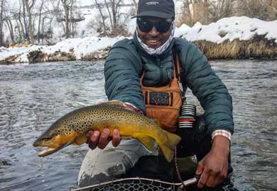 Jans fly fishing guide Sam Elam catches a fish while winter fly fishing.