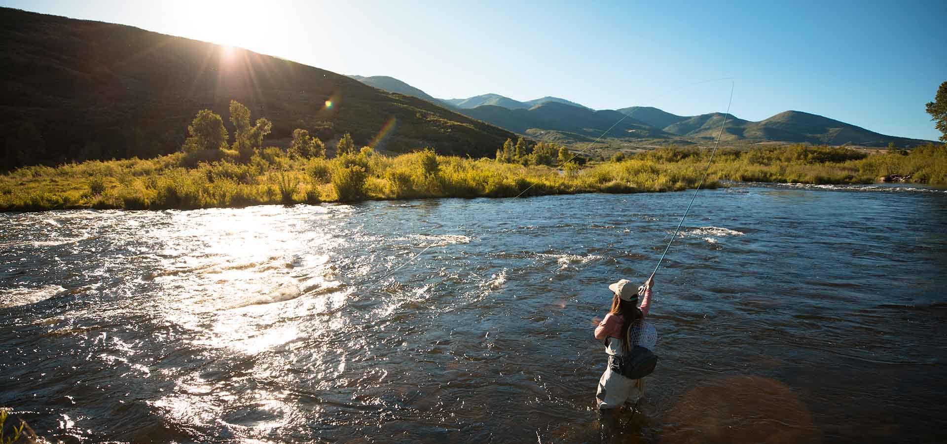 Jans Expert fly fishing at sunset on a river near Park City, UT.