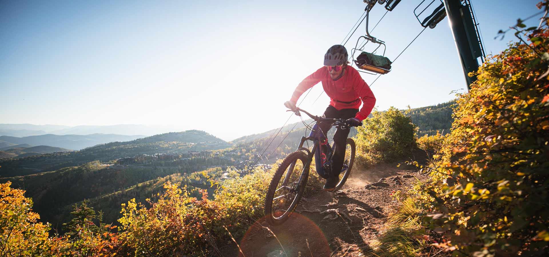 Jans expert rides on a mountain bike trail below a chairlift in Deer Valley Resort, Park City, UT