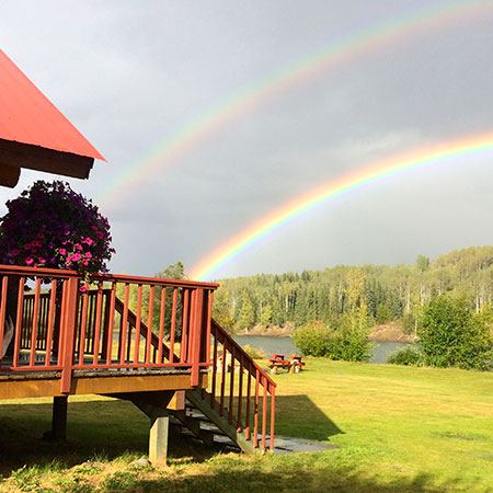 Two rainbows shine above the Bulkley River Lodge in British Columbia.