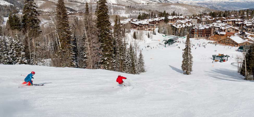 Two skiers on a groomer run at Deer Valley, Park City, UT