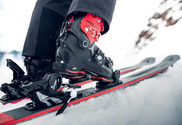 Atomic ski boot about to be clicked into an Atomic ski binding.