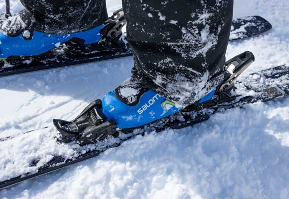 A skiers boot clicked into a binding on snow in Park City, UT