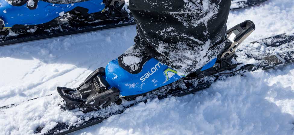 A skiers boot clicked into a binding on snow in Park City, UT