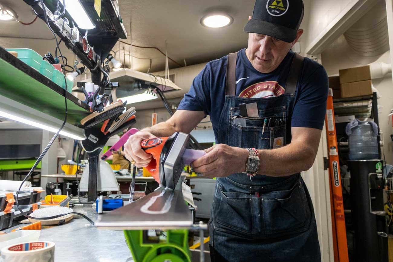 Andy Buckley waxes a pair of skis at the Jans Rennstall World Class Tune Center in Park City, Utah.