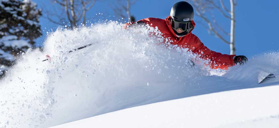 Skier slashes a turn in fresh snow at Deer Valley Resort in Park City, Utah.