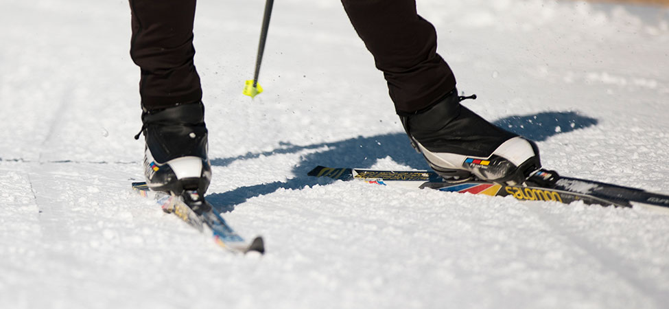 Nordic ski boots on skis on snow