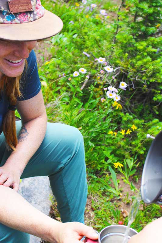 Jans experts prepare tea to stay hydrated in the Uinta Mountains, Utah.