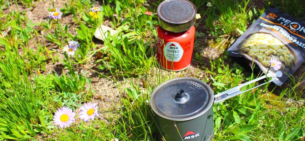 A MSR canister backpacking stove with integrated cooking pot.