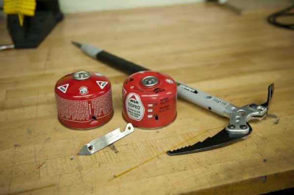 Empty fuel canisters with holes ready to be recycled. Image courtesy of MSR.