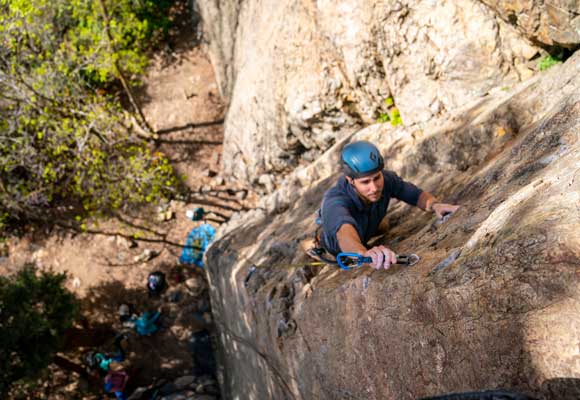 Jans expert clipping a bolt while sport climbing in Big Cottonwood Canyon, Utah.