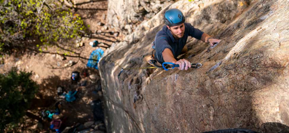 Jans expert clipping a bolt while sport climbing in Big Cottonwood Canyon, Utah.