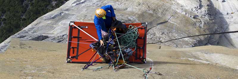 A big wall climber belaying from a portaledge. Image courtesy of Metolius.
