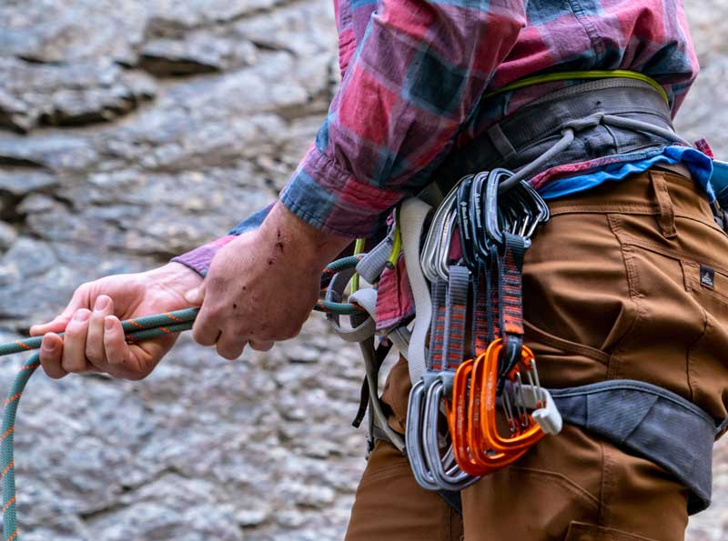 Jans expert tying in—the climbing rope goes through the hard points of the leg loops and waist belt. Quickdraws are racked on gear loops.