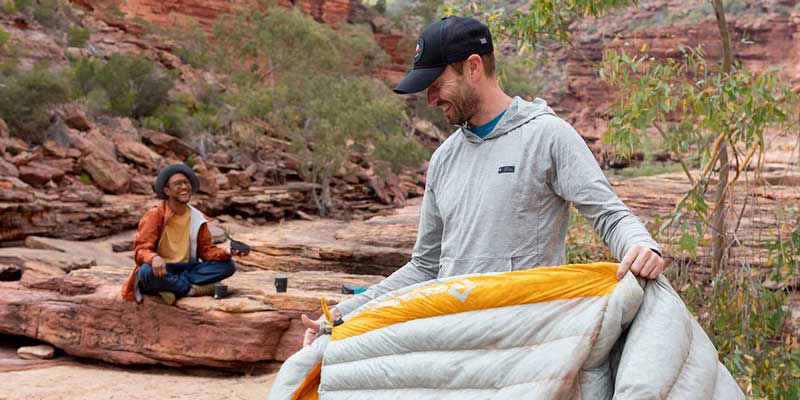 A camper packs his sleeping bag. Image courtesy of Sea to Summit.