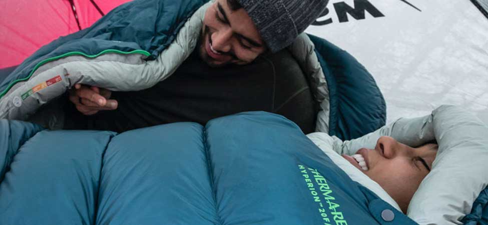 Campers enjoying a warm rest in their sleeping bags. Image courtesy of Thermarest.
