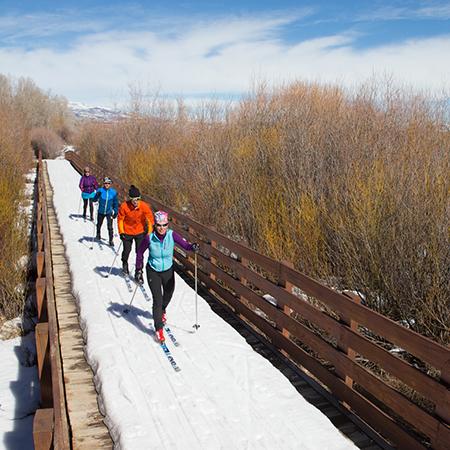 A cross country ski guide leads clients along the McCleod Creek Trail in Park City, Utah.