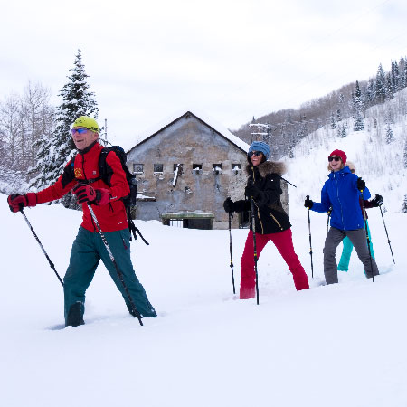 Jans snowshoe guide leads a tour past Judge Mine Tunnel in Park City, Utah.
