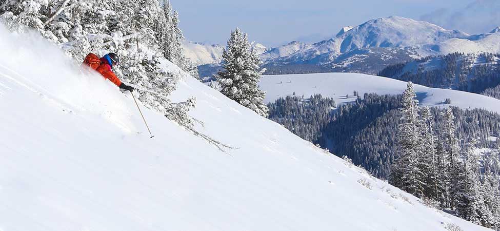 Backcountry ski guide skis untouched powder at Thousand Peaks Ranch in the Uinta Mountains.