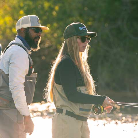 Jans fly fishing guide Billy Cosby teaches a client how to fly fish.