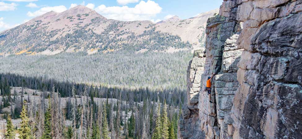 White Pine Touring rock climbing guide leads a rock climbing tour in the Uinta mountains.