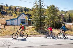 Jans road bike guide leads a tour past a historical site in Park City, Utah.