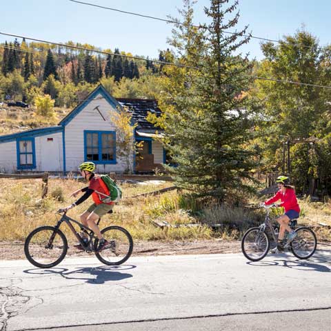 Jans road bike guide leads a tour past a historical site in Park City, Utah.