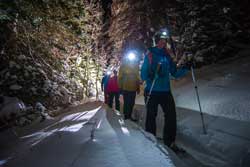 Jans guide Cindi Grant leads a moonlight snowshoe tour in Empire Canyon in Park City, Utah.