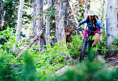 Jans expert Shaun Raskin-Deutschlander weaves her way through the aspen trees on a mountain bike trail in Park City, Utah.