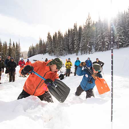 Avi Level 1 instructor and student digging a snow pit.