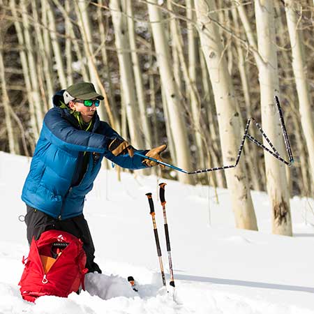 AIARE Pro Avalanche Instructor deploying a probe during training drill.