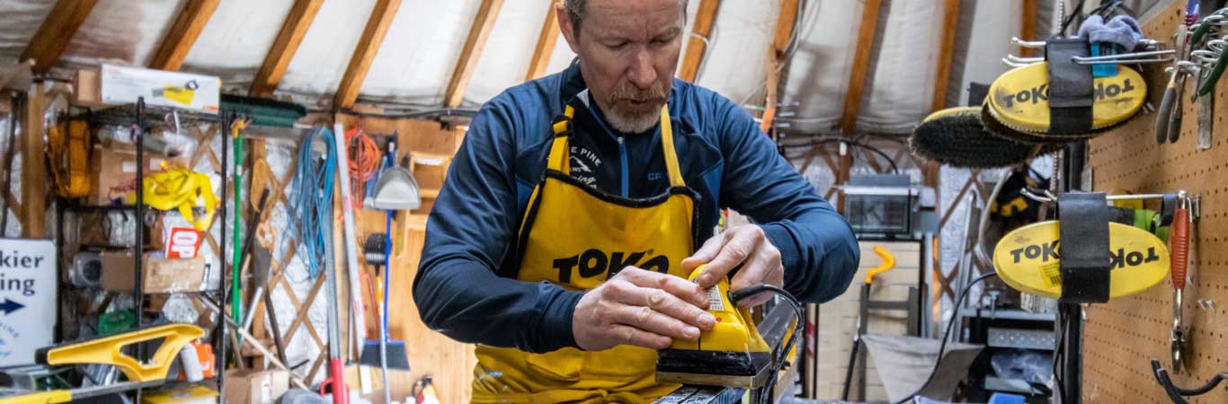 A man waxes Nordic skis at the White Pine Nordic Center in Park City, UT