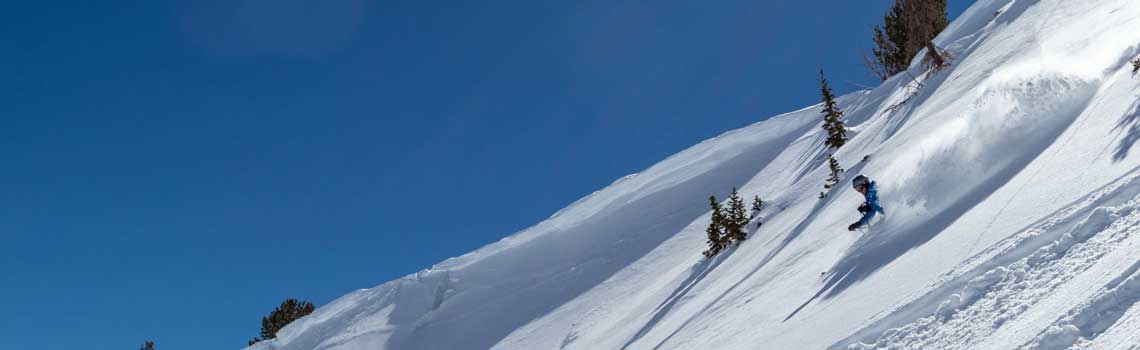 A single skier making a powder turn near Park City, UT